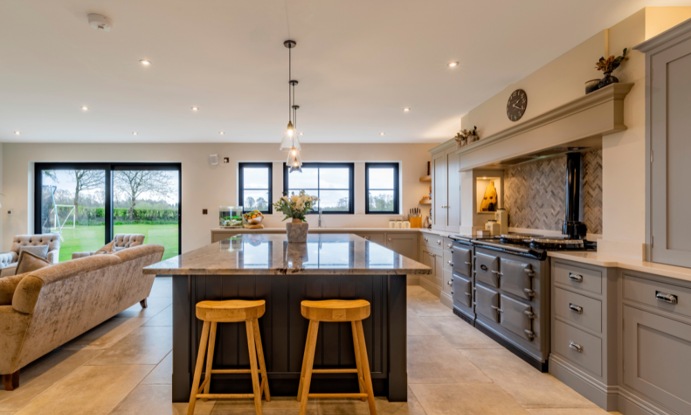 A picture of a large kitchen with an island and an aga cooker as the focal points