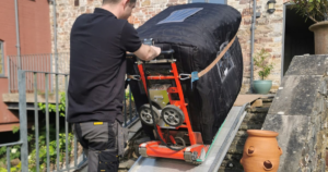 A picture showing range exchange delivering and installing a reconditioned aga cooker