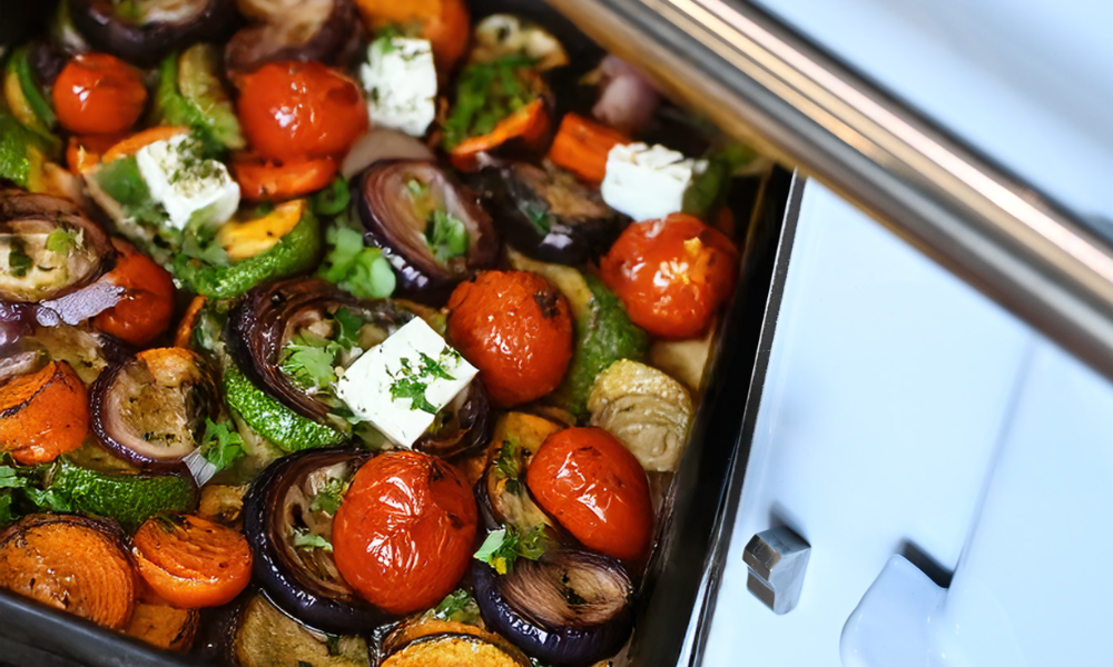 picture of a tray full of roasted veg coming out of the aga roasting oven